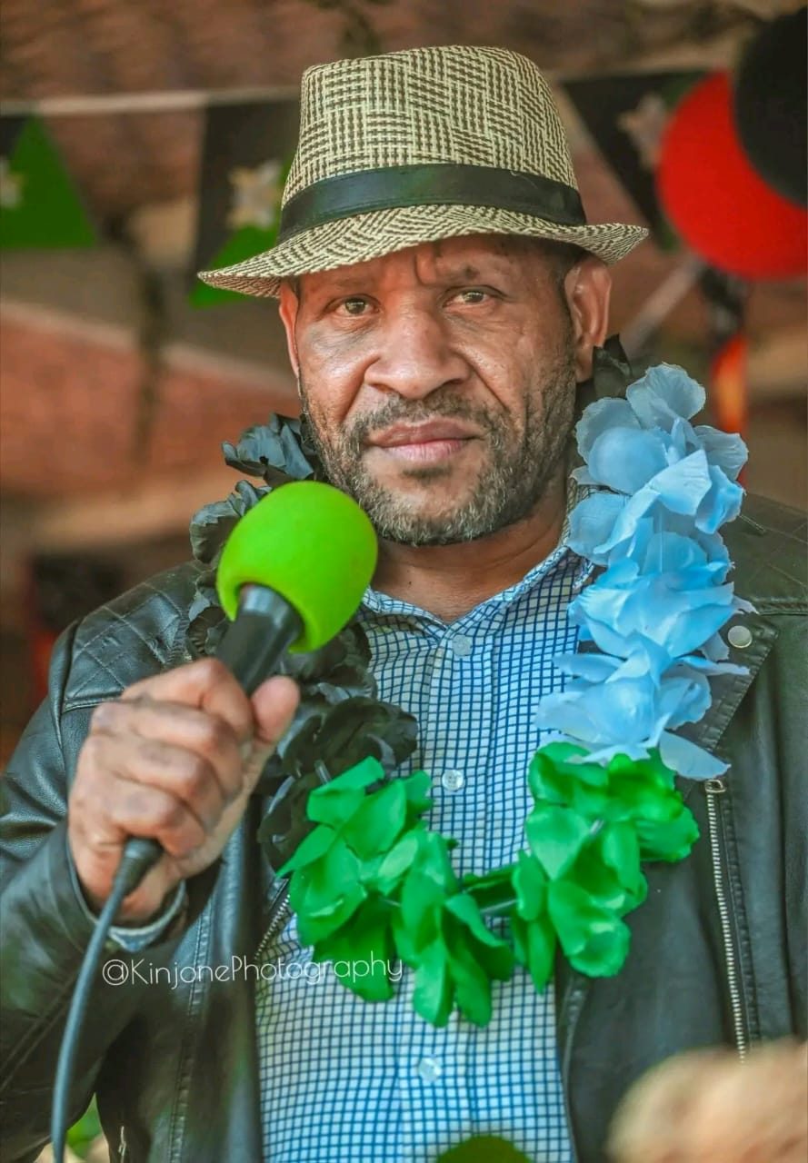 Speaker addressing the crowd at a Poketamanda community event