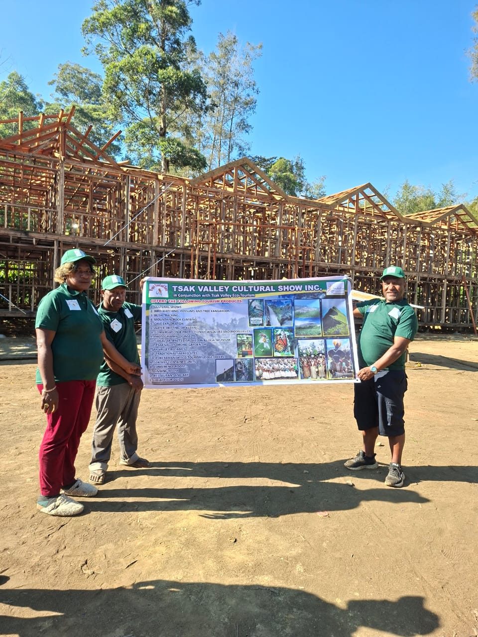 Team with the Poketamanda Eco Tourism Lodge banner
