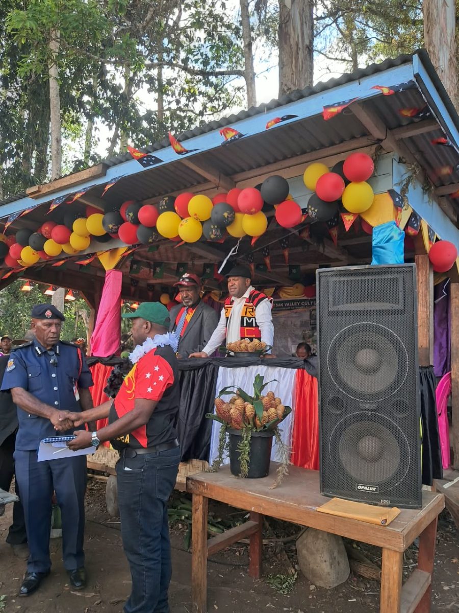 Officials beside the decorated stage at the event